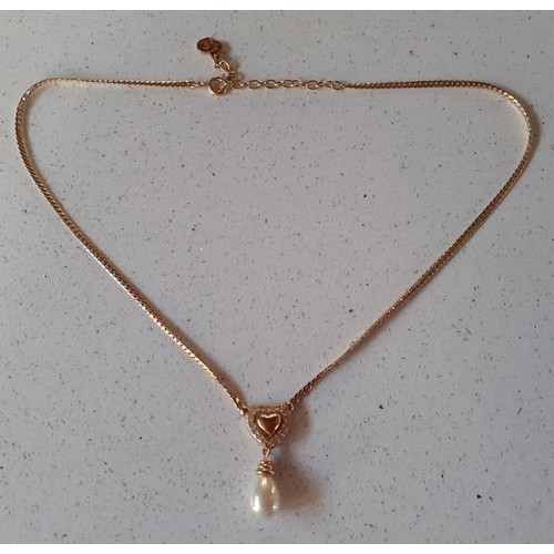 1 - Christian Dior- A late 20th Century gold tone heart and faux pearl drop necklace having a CD charm t... 