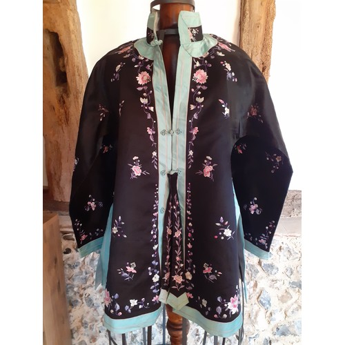 44 - A 20th Century Chinese machine embroidered black silk jacket with turquoise border and Mandarin coll... 