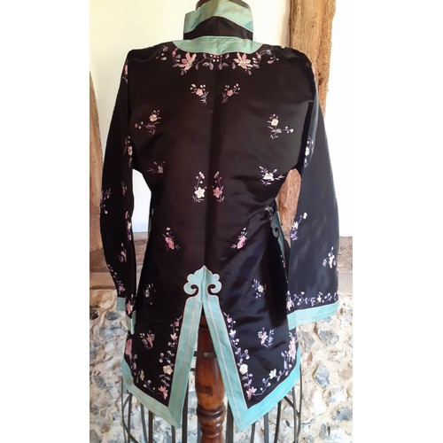 44 - A 20th Century Chinese machine embroidered black silk jacket with turquoise border and Mandarin coll... 