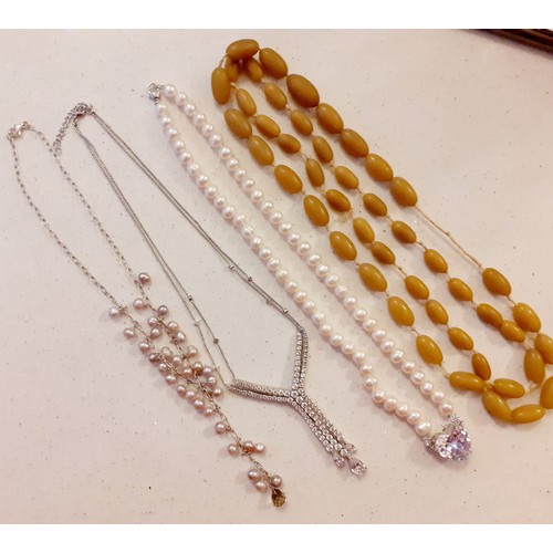 50 - Four vintage necklaces to include simulated pearls and a white tone and white paste stone necklace. ... 