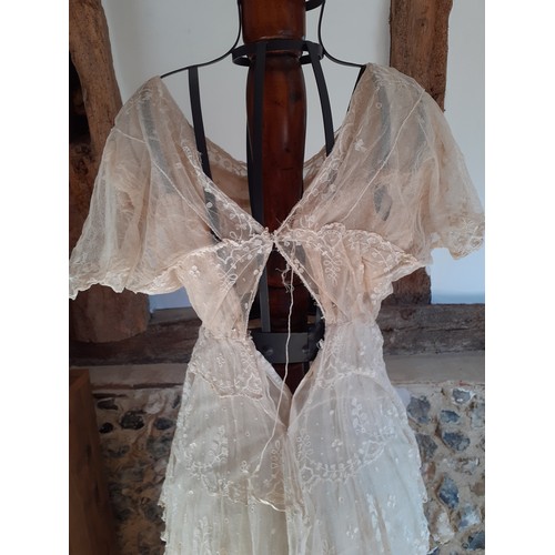 39 - An Edwardian cream dress A/F with embroidered swags, swirls and floral sprays on a button mesh groun... 