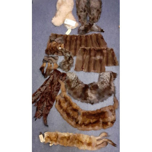 100 - A quantity of vintage fur wraps, collars, insertions and remnants to include a wolf stole, a fox col... 