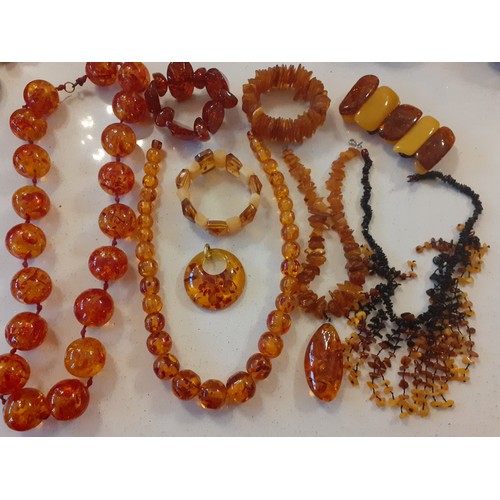 54 - Three vintage rough cut amber necklaces, one having a teardrop pendant on gold tone links and 2 roug... 