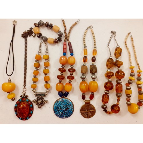 57 - Vintage Worldwide costume necklaces and bracelet to include a Moroccan silver tone and amber bead ne... 