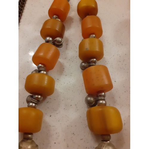 57 - Vintage Worldwide costume necklaces and bracelet to include a Moroccan silver tone and amber bead ne... 