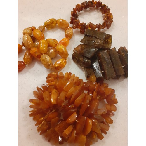 66 - Late 20th Century costume jewellery to include an amber rough cut necklace and 2 amber bracelets tog... 