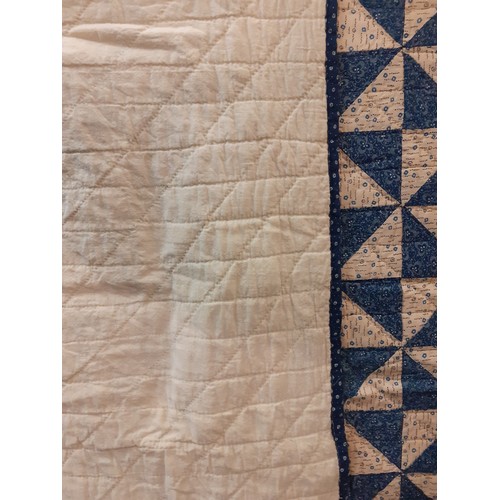 46 - A 1960's American Mid West vintage handmade double layer patchwork quilt in blue and cream having sm... 