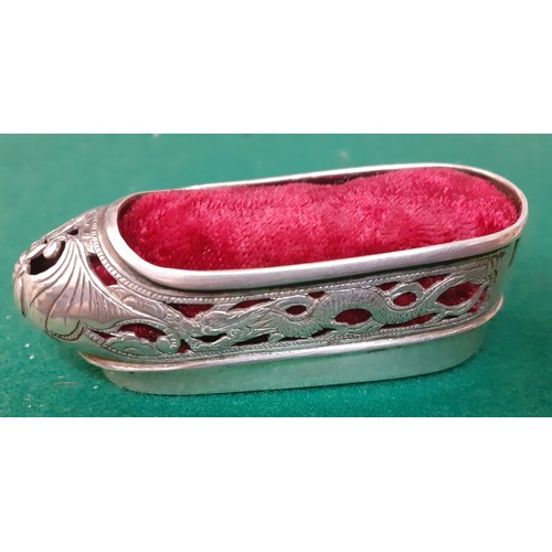 105 - A 20th Century Chinese white metal pin cushion in the form of a slipper with red velvet cushion toge... 