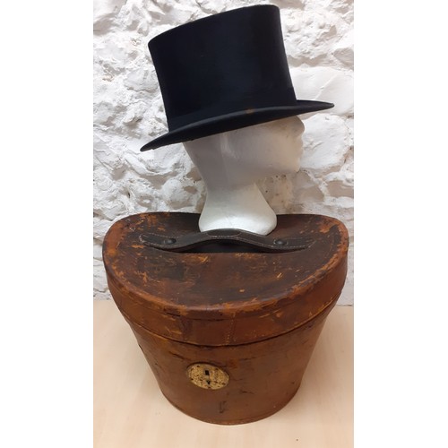 48 - A Victorian brown leather top hat box with fitted red silk interior having a Continental travel stic... 