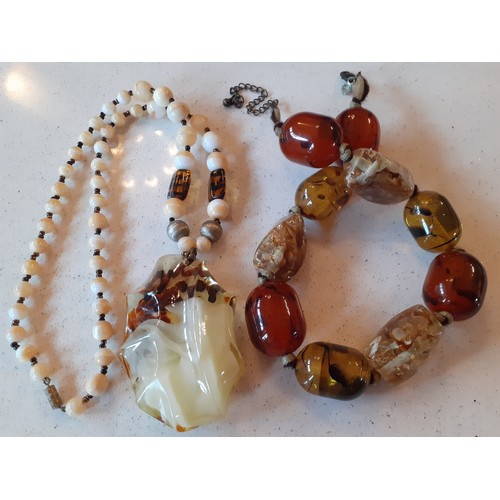 68 - Amber and amber effect costume jewellery to include a vintage brown amber necklace with faceted bead... 