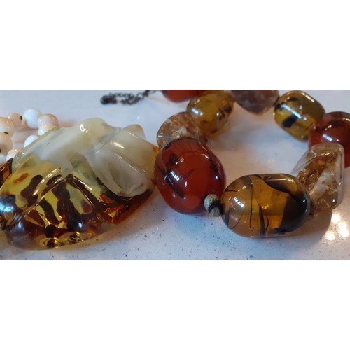 68 - Amber and amber effect costume jewellery to include a vintage brown amber necklace with faceted bead... 