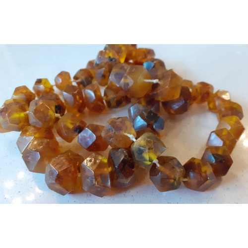 68 - Amber and amber effect costume jewellery to include a vintage brown amber necklace with faceted bead... 