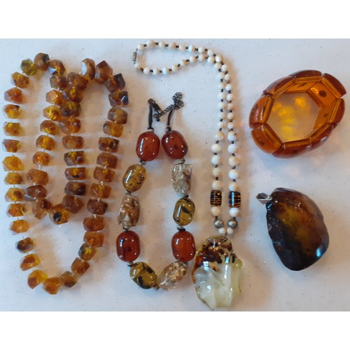 68 - Amber and amber effect costume jewellery to include a vintage brown amber necklace with faceted bead... 