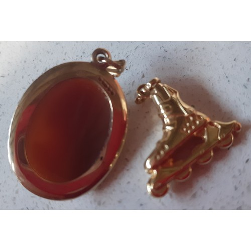 58 - A small 9ct gold cameo pendant stamped 375 and a small 18ct gold charm in the form of an inline-skat... 