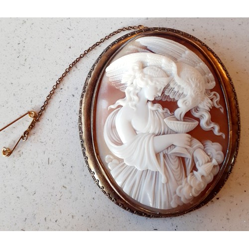 61 - A pinchbeck cameo brooch of Hebe The Goddess of Youth and The Eagle of Justice in a gilt metal frame... 