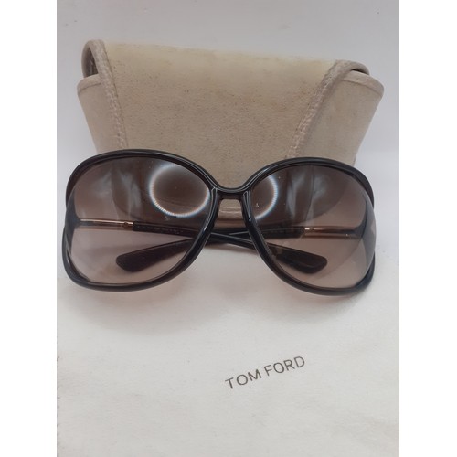 14 - Tom Ford-A pair of brown framed sunglasses with brown ombre lenses and gold tone temples, Model 'Raq... 