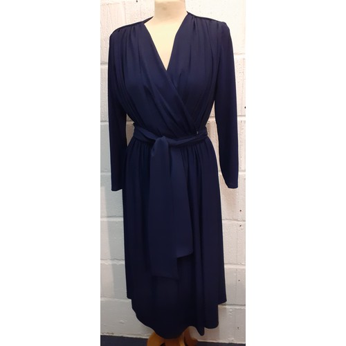 118 - A late 1970's Trina Lewis & Marjon Couture navy wrap-around dress with plunge neckline, UK size 14. ... 