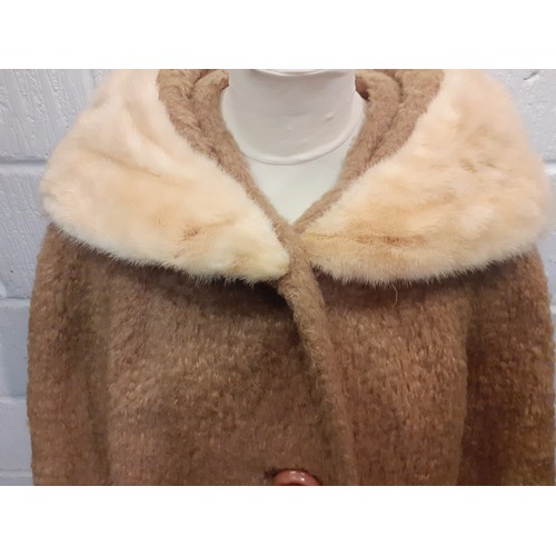 77 - A mid 20th Century American B.Forman & Co tan boucle lambswool swing ladies coat having an arctic mi... 