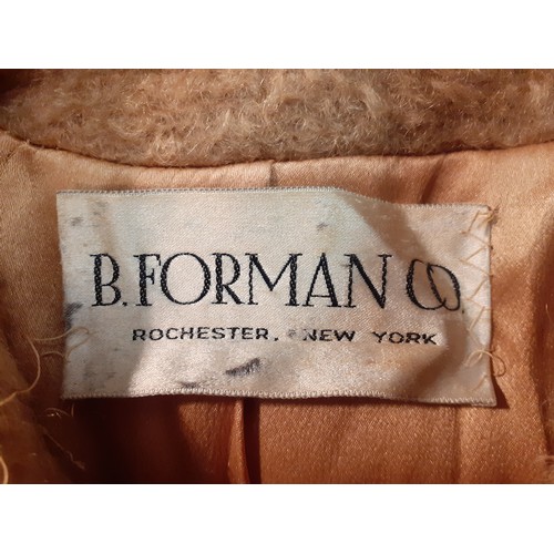 77 - A mid 20th Century American B.Forman & Co tan boucle lambswool swing ladies coat having an arctic mi... 