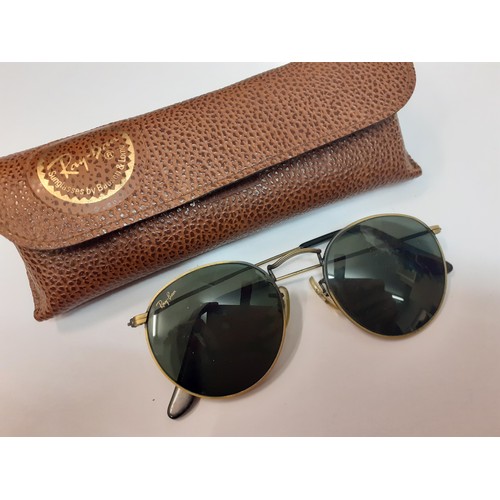 64 - Ray Ban-A pair of vintage brushed gold tone sunglasses with circular green lenses, model no; WO967 X... 