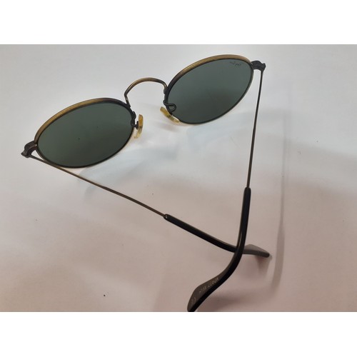 64 - Ray Ban-A pair of vintage brushed gold tone sunglasses with circular green lenses, model no; WO967 X... 