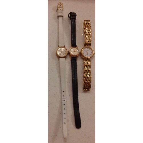 83 - Three ladies cocktail watches to include a gold tone Raymond Weil watch, a Tissot watch on a cream l... 