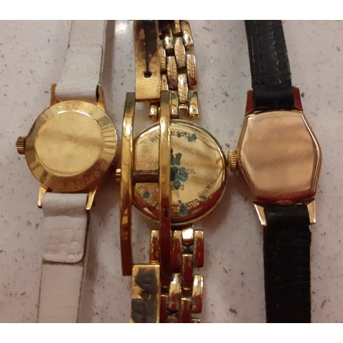 83 - Three ladies cocktail watches to include a gold tone Raymond Weil watch, a Tissot watch on a cream l... 