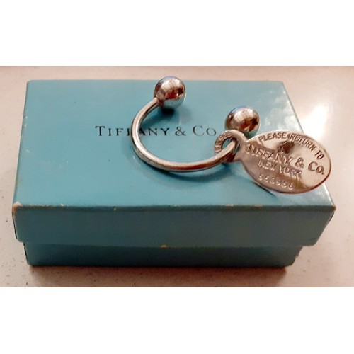 90 - Tiffany & Co-A silver 'Return to Tiffany' keyring, No:553958 in the horseshoe style with ball ends a... 