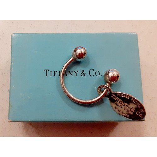 90 - Tiffany & Co-A silver 'Return to Tiffany' keyring, No:553958 in the horseshoe style with ball ends a... 