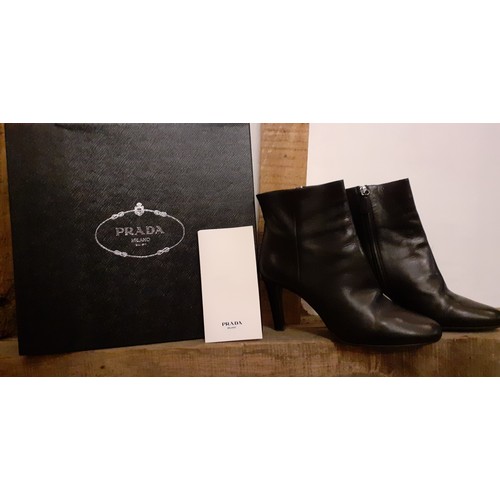 19 - Prada- Circa 2015, a pair of 'Calzature Vitello Nero 39' ladies black leather ankle boots, as new, w... 