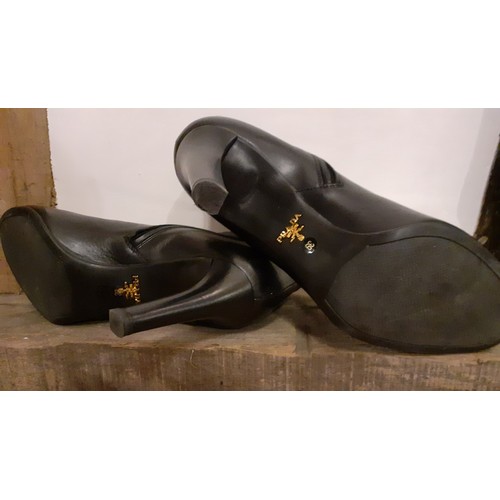 19 - Prada- Circa 2015, a pair of 'Calzature Vitello Nero 39' ladies black leather ankle boots, as new, w... 