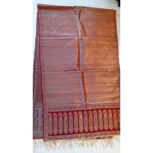 91 - An Indian machine made metallic thread shawl having a red ground with a boteh border and gold metall... 