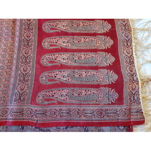 91 - An Indian machine made metallic thread shawl having a red ground with a boteh border and gold metall... 