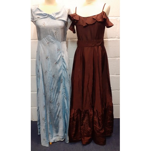 99 - Two mid 20th Century evening gowns, one in baby blue  with floral sprays and a shawl neckline, the o... 