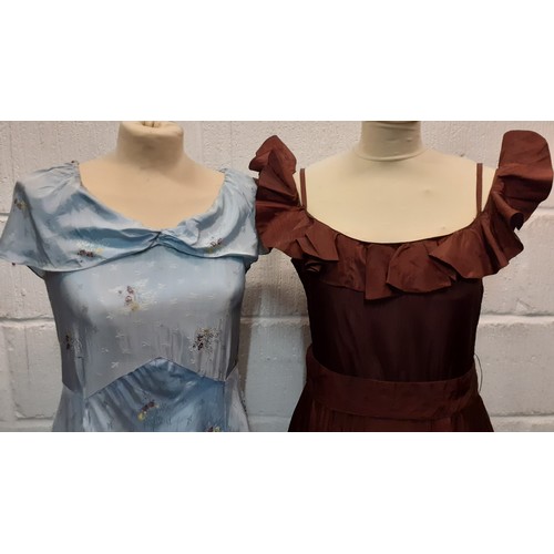 99 - Two mid 20th Century evening gowns, one in baby blue  with floral sprays and a shawl neckline, the o... 