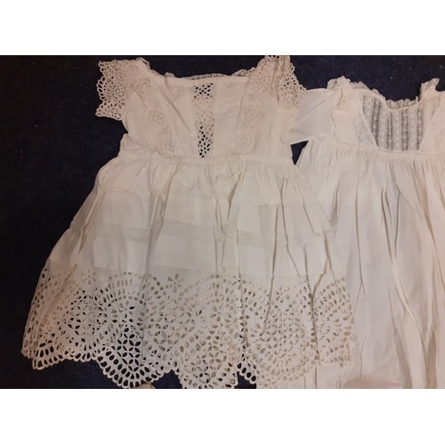 122 - Early 20th Century children's clothing to include white cotton christening dresses, a cream silk gir... 