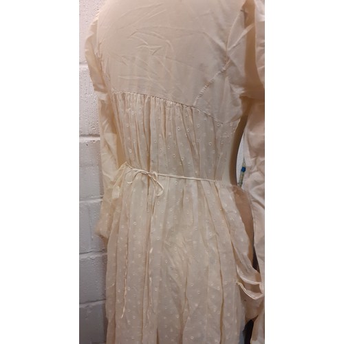 123 - A late 19th/early 20th Century bespoke cream cotton maternity night gown with a central section havi... 