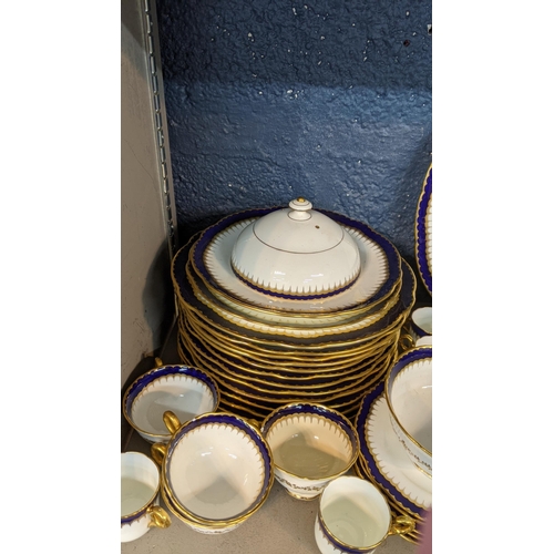 223 - An early 19th/20th century Coalport cobalt blue and white dinner service having gold coloured candle... 