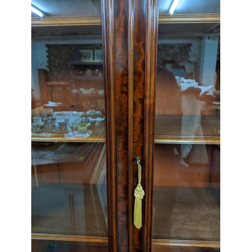 280 - An early 20th century walnut bookcase side cupboard stepped cornice over trim glazed display doors w... 