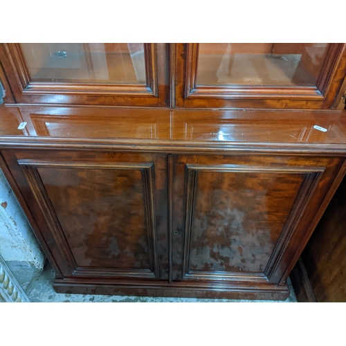 280 - An early 20th century walnut bookcase side cupboard stepped cornice over trim glazed display doors w... 