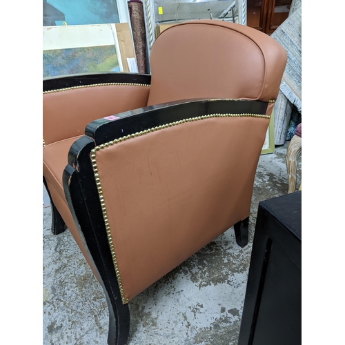 309 - An Art Deco black painted wooden framed arm chair with a brown faux leather upholstery
Location:G