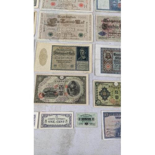 329 - Banknotes to include a French 1792 Revolution, Japanese Government and German examples Location:CAB1