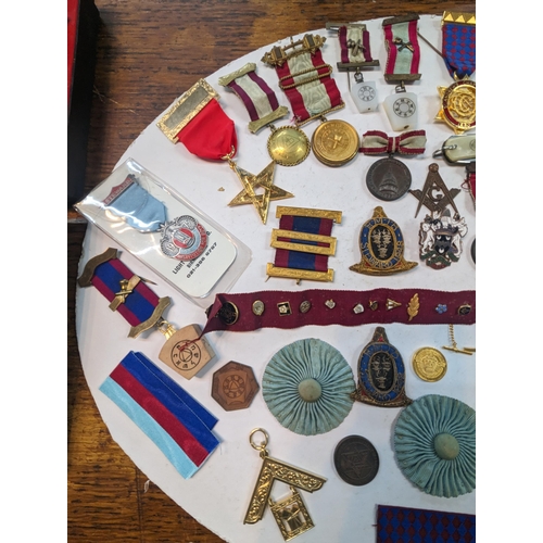 47 - A collection of Masonic related times to include medals, tokens, badges and others along with a name... 