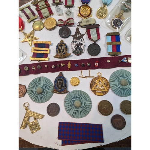 47 - A collection of Masonic related times to include medals, tokens, badges and others along with a name... 