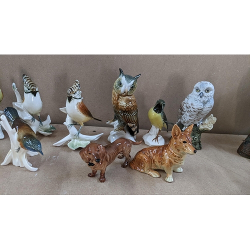 13 - A selection of porcelain animal ornaments to include Karl Ens birds, Bretby style majolica spill vas... 