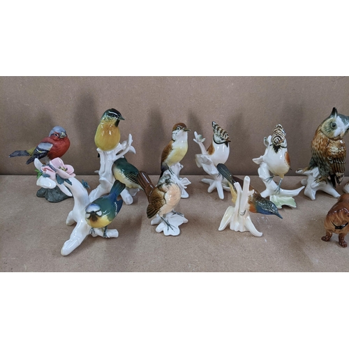 13 - A selection of porcelain animal ornaments to include Karl Ens birds, Bretby style majolica spill vas... 