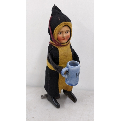 18 - A 1930s Schuco toy of a child drinking monk
Location:4.1