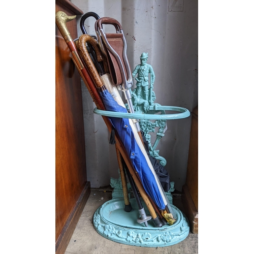 92 - A cast iron green painted stick stand, together with shooting sticks and walking sticks including a ... 