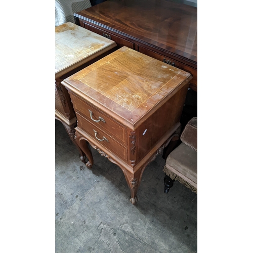 98 - A pair of reproduction French bedside tables having two drawers, floral carved decoration and on cab... 