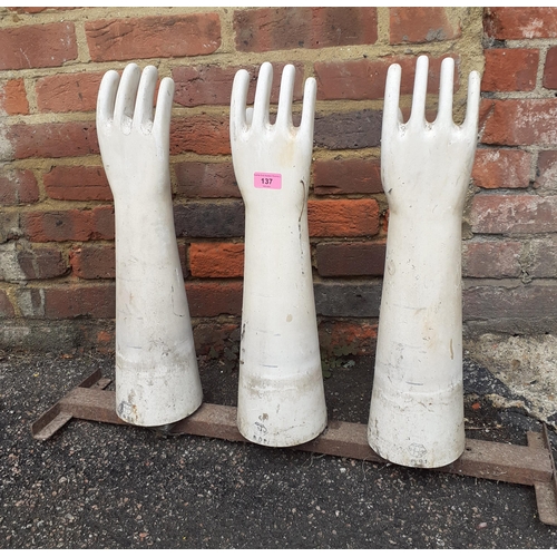 162 - A set of three vintage ceramic latex glove moulds, on a metal stand produced by AHG. Location:BWR